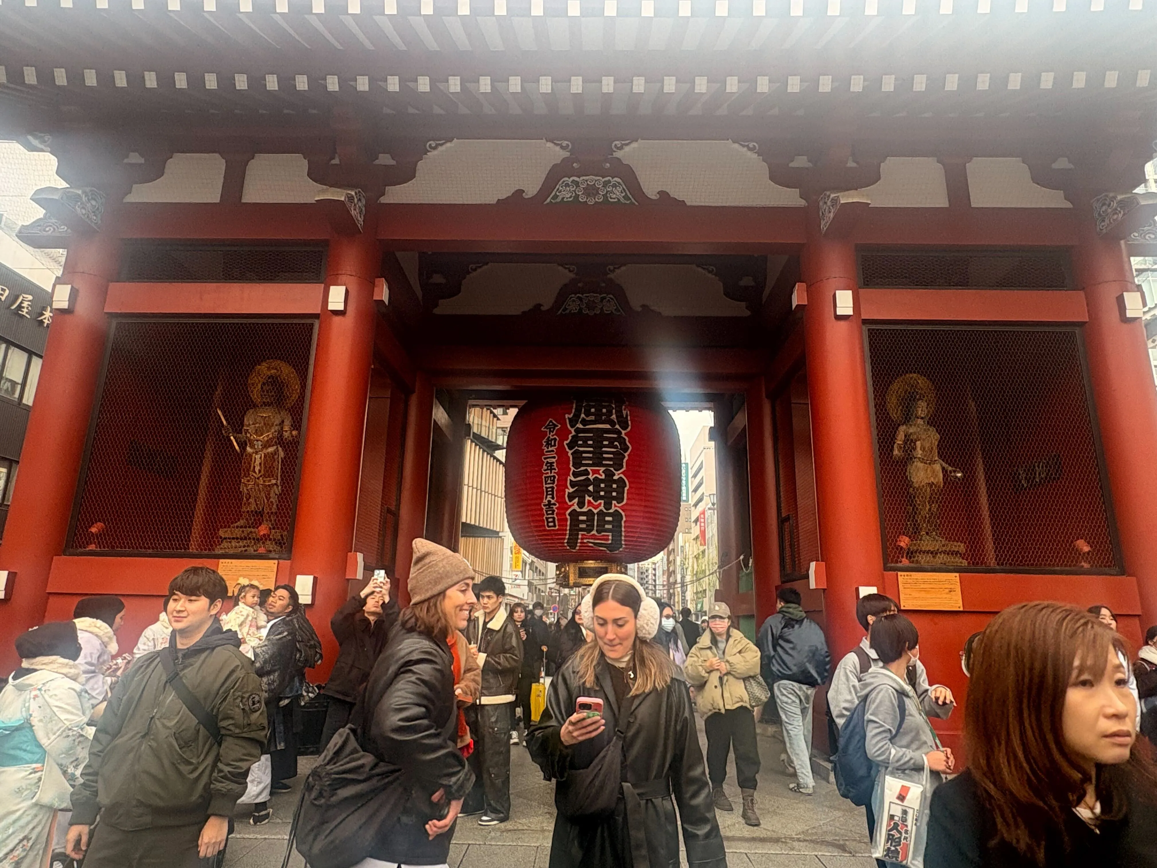 Travelers beneath Kaminarimon Gate in Asakusa