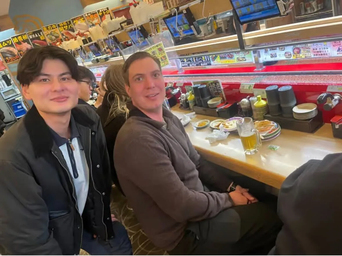 A guide and guests sharing a meal at a Tokyo restaurant
